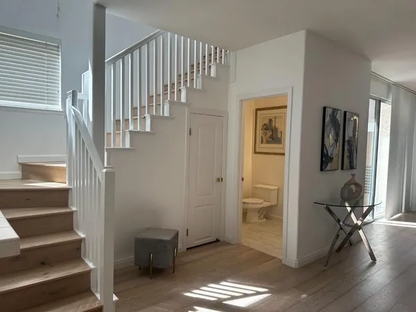 a view of entryway with wooden floor and stairs