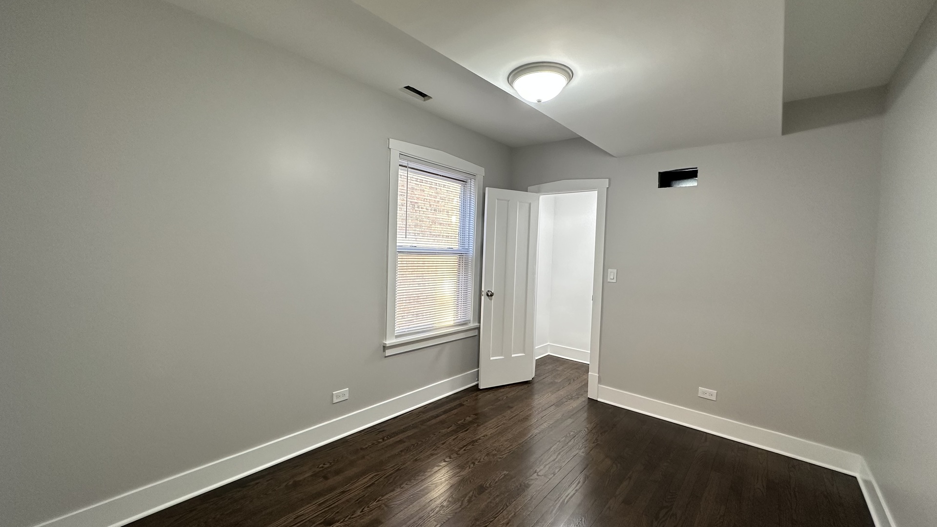 5224 North Bernard Street, Unit 2 Chicago, IL 60625 - Photo 10 of 13 an empty room with wooden floor and windows