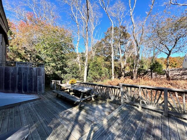 140 Harvest Road Eastham, MA 02642 - Photo 19 of 25 a wooden bench sitting in front of a building