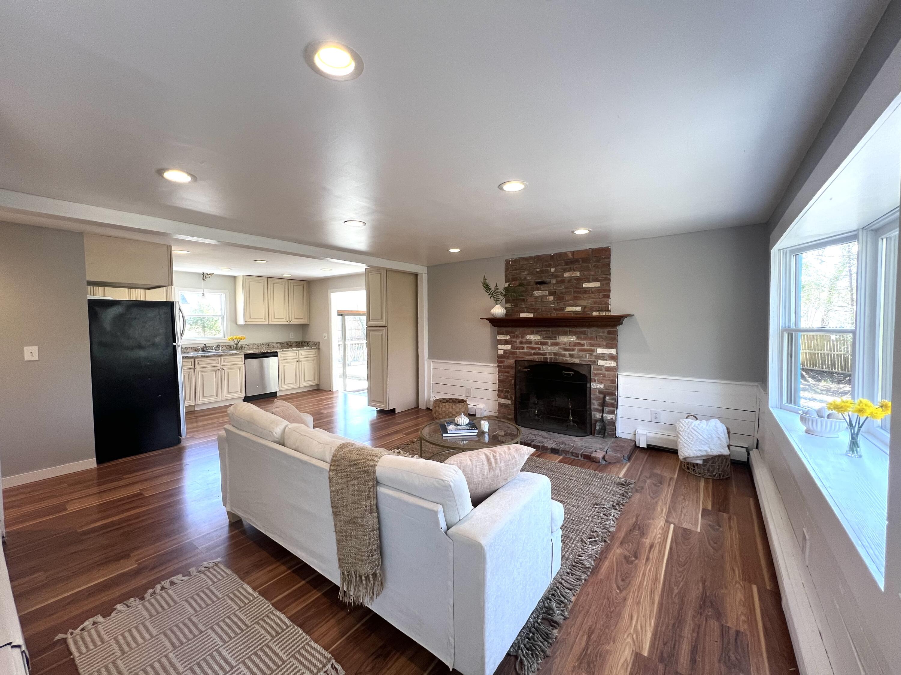 140 Harvest Road Eastham, MA 02642 - Photo 2 of 25 a living room with furniture and a fireplace