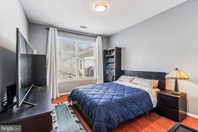 a bathroom with a sink a toilet a mirror a bathtub and shower