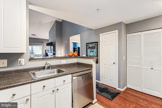 a kitchen with granite countertop a sink and a stove
