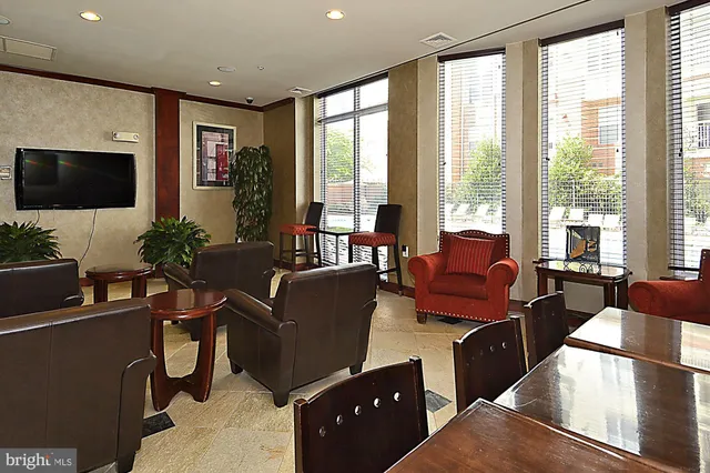 a view of a hallway with wooden floor and a workspace