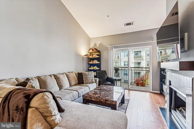 a living room with fireplace furniture and a flat screen tv