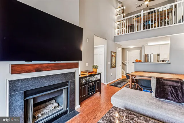 a living room with furniture a fireplace and a flat screen tv