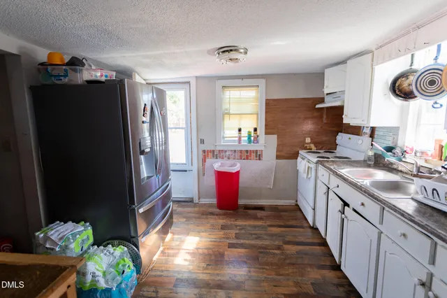 a kitchen with a refrigerator and a sink