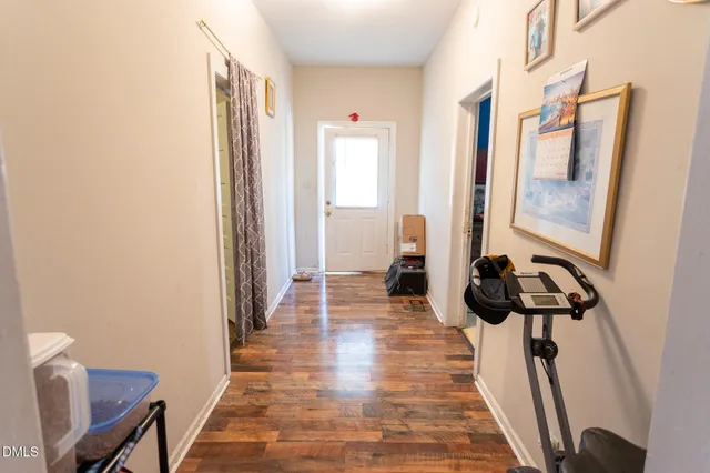 a view of a hallway to a livingroom and a window