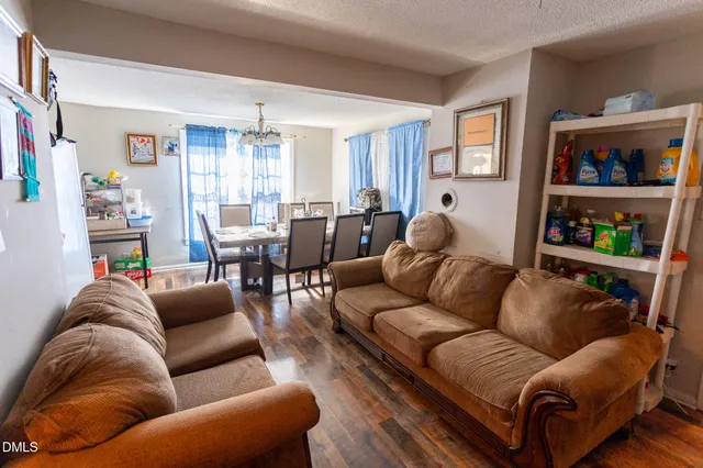 a living room with furniture cabinets and window