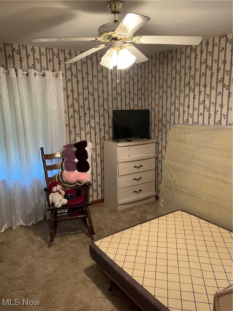 12924 Orme Road Cleveland, OH 44125 - Photo 11 of 27 Bedroom with wallpapered walls, ceiling fan, and carpet