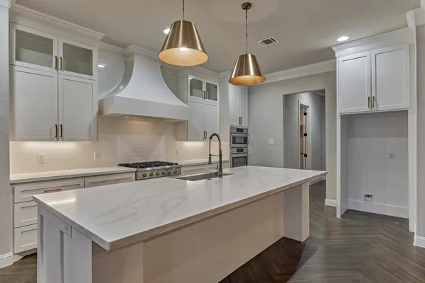 a kitchen with a sink stove and refrigerator