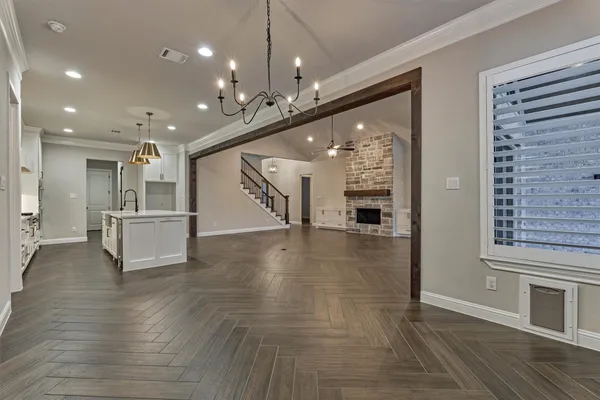 a spacious bedroom with a large bed and a chandelier