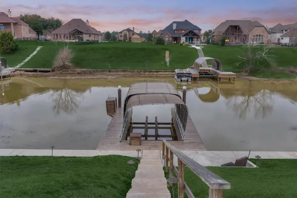 aerial view of a house with a garden and a lake view