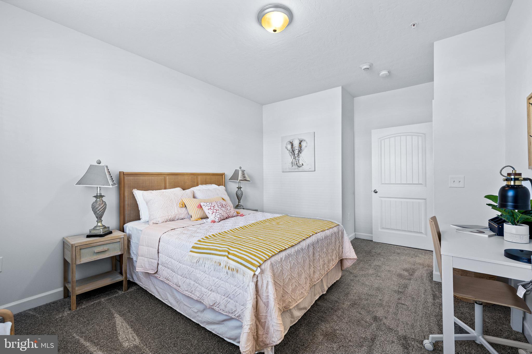 1201 Walnut Bottom Road, Unit 100103 Carlisle, PA 17015 - Photo 16 of 32 a bedroom with a bed and a potted plant