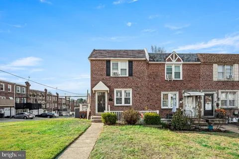 a front view of a building with a garden