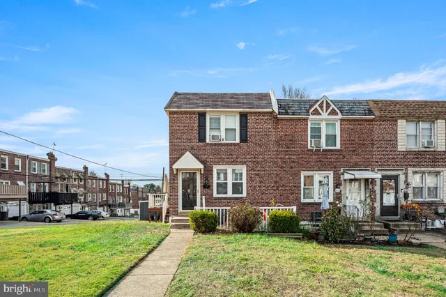 a front view of a building with a garden