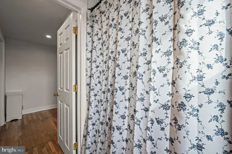 a bathroom with a shower curtain and a sink