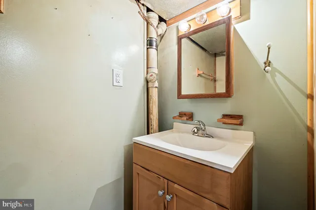 a bathroom with a sink and mirror