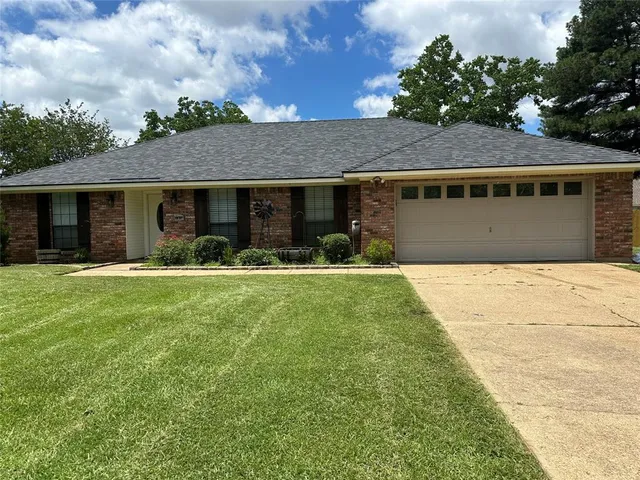 a front view of house with yard and green space