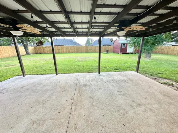 a view of a house with backyard and porch