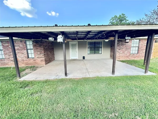 a view of a house with a porch and furniture