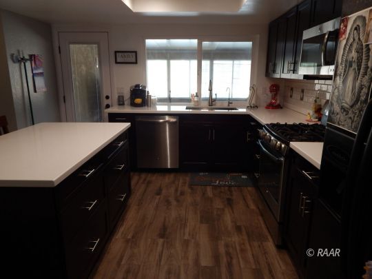 517 Suzanne Street Ridgecrest, CA 93555 - Photo 17 of 34 a kitchen with a sink a stove a refrigerator and a oven
