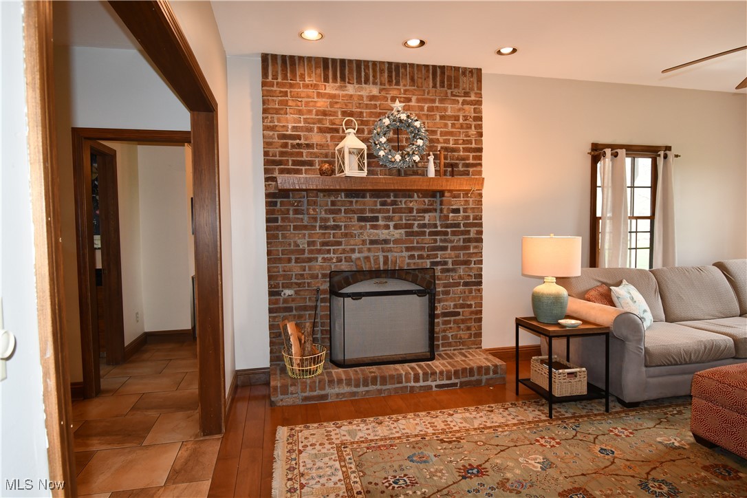 3180 West Calla Road Canfield, OH 44406 - Photo 19 of 49 Living room with recessed lighting, a fireplace, baseboards, and wood finished floors