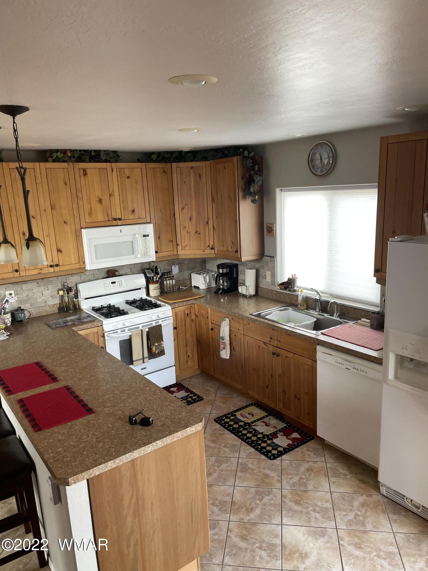 7 County Road Concho, AZ 85924 - Photo 21 of 21 a kitchen with stainless steel appliances granite countertop a stove a sink and a microwave