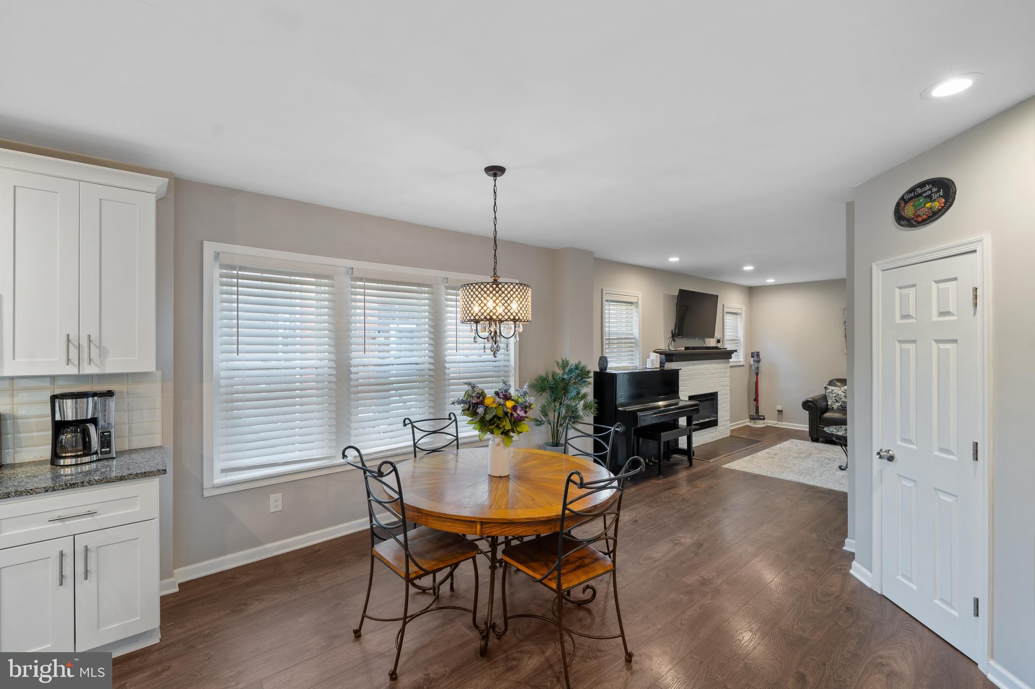 261 East Avon Road Brookhaven, PA 19015 - Photo 11 of 34 a living room with furniture a dining table and a fireplace