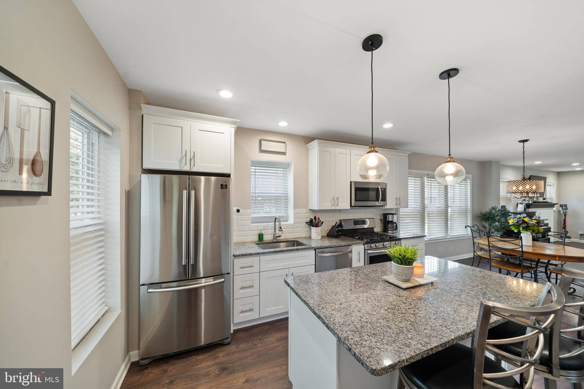 261 East Avon Road Brookhaven, PA 19015 - Photo 15 of 34 a kitchen with stainless steel appliances granite countertop a kitchen island a stove a table and chairs