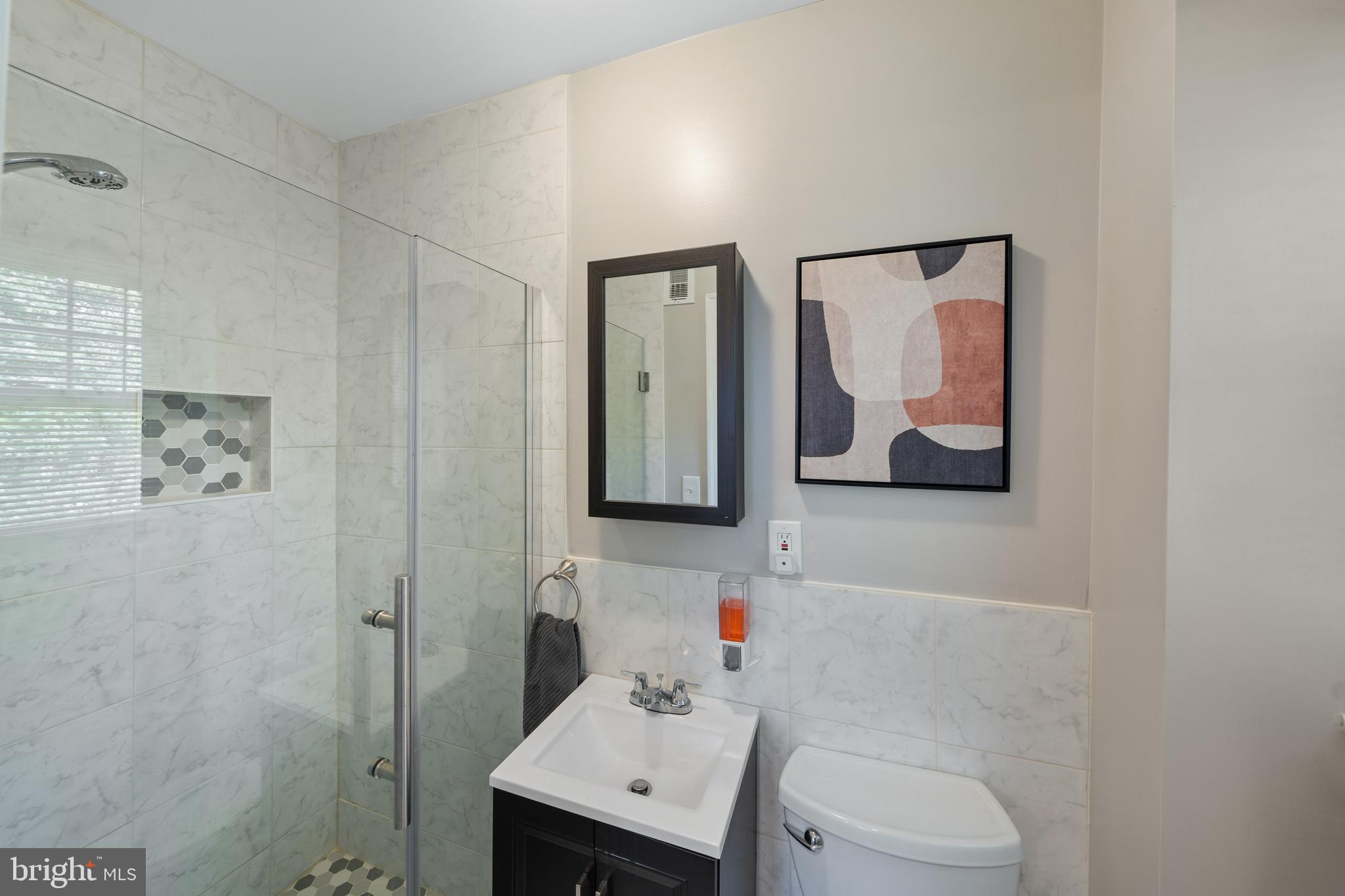 261 East Avon Road Brookhaven, PA 19015 - Photo 16 of 34 a bathroom with a toilet sink and mirror