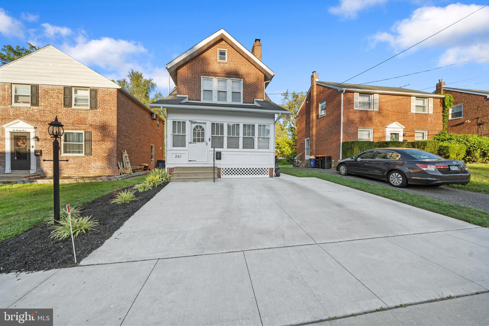 261 East Avon Road Brookhaven, PA 19015 - Photo 3 of 34 a front view of a house with a garden