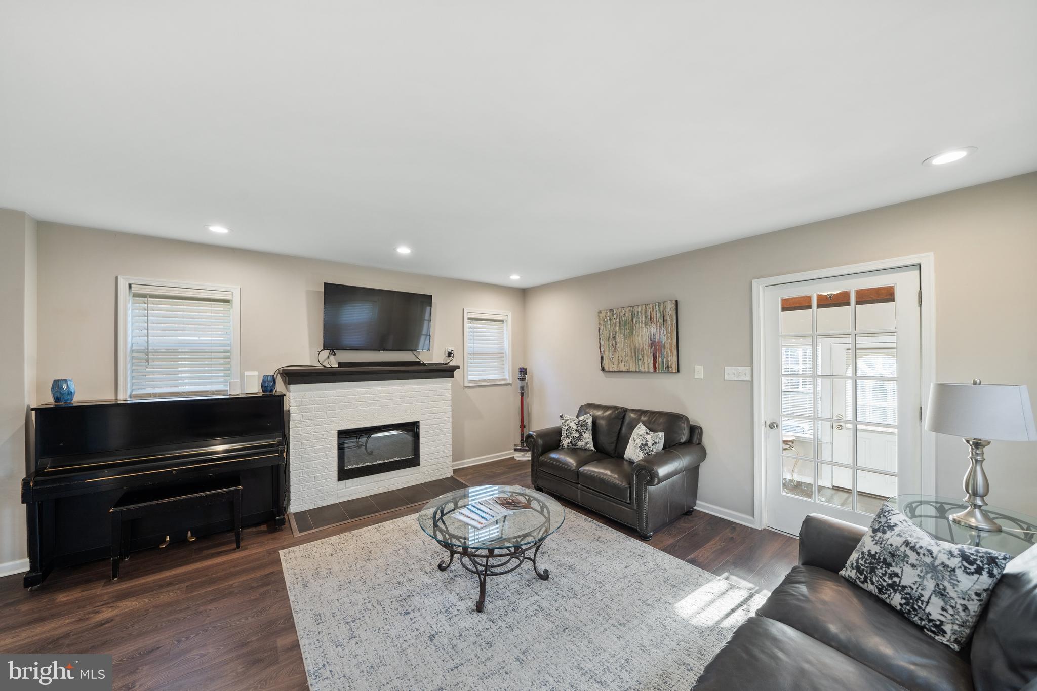 261 East Avon Road Brookhaven, PA 19015 - Photo 9 of 34 a living room with furniture a flat screen tv and a fireplace