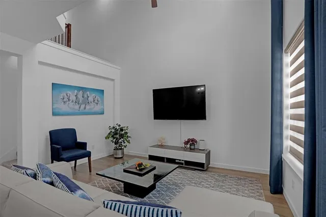 a living room with furniture a rug and a flat screen tv