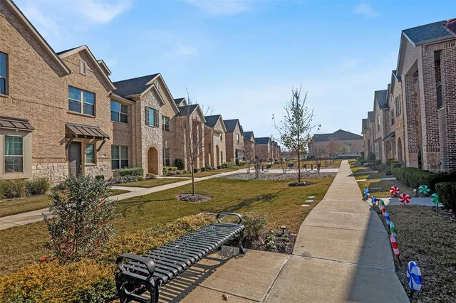 a view of a white house with a yard and furniture