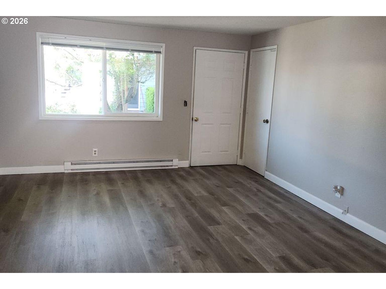 3124 19th Place Forest Grove, OR 97116 - Photo 4 of 31 an empty room with wooden floor and windows