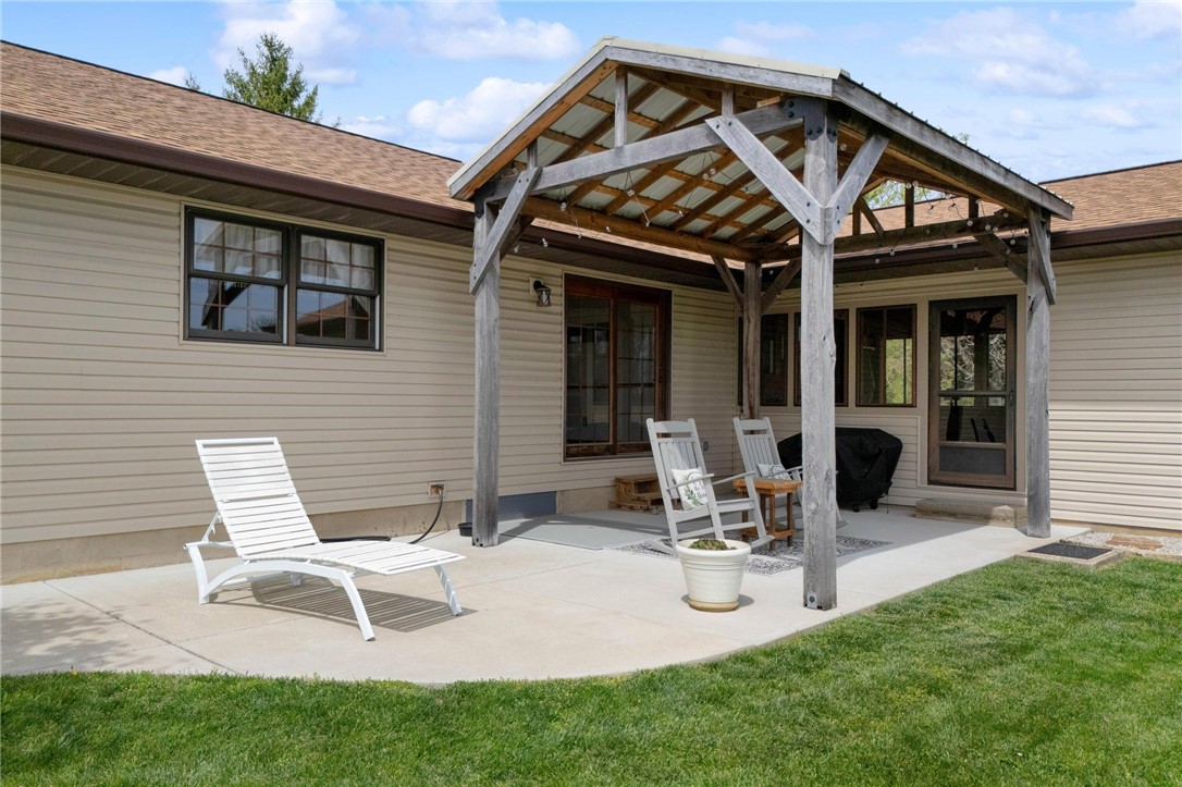 4971 Lackey Road Cedarville, OH 45314 - Photo 9 of 79 Relax outdoors on the spacious patio with a charming pergola and lush green yard.
