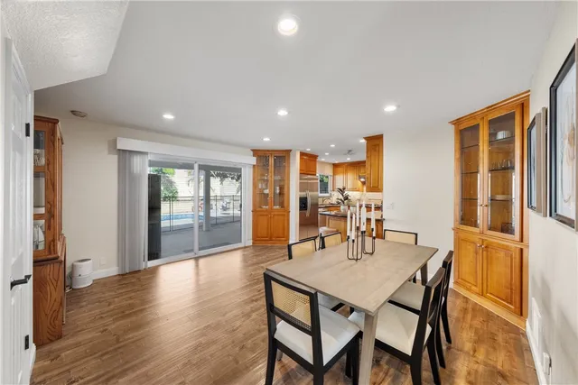 a dining room with furniture and wooden floor