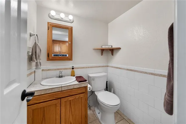a bathroom with a sink toilet and mirror