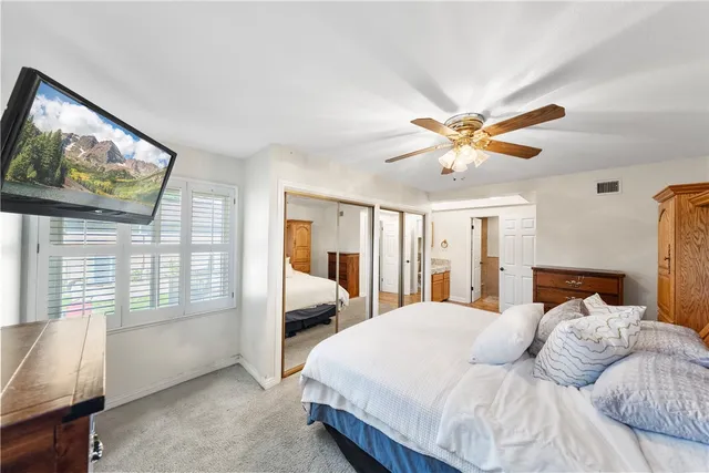 a bedroom with a large bed and a large window