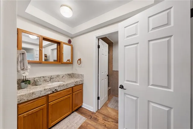 a bathroom with a granite countertop sink and a mirror