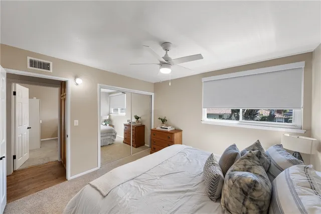 a bedroom with a bed and a view of kitchen
