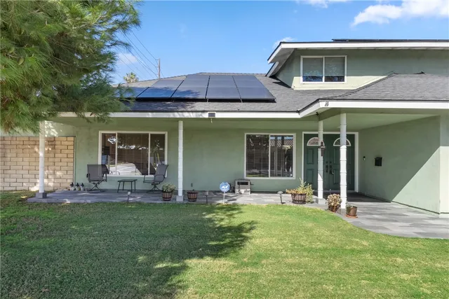 a backyard of a house with outdoor seating
