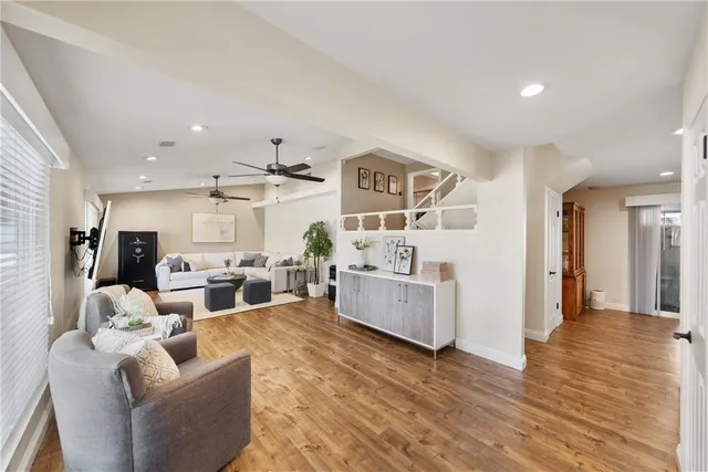 a living room with furniture and wooden floor
