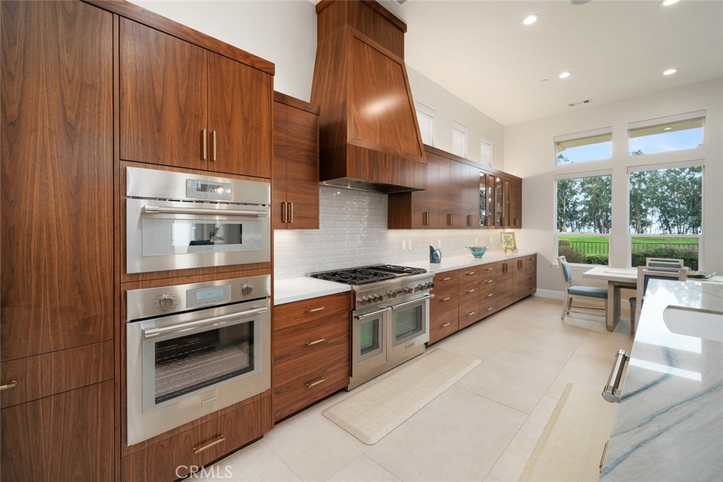 1988 Eucalyptus Road Nipomo, CA 93444 - Photo 11 of 63 a kitchen with stainless steel appliances kitchen island granite countertop a stove a sink and a refrigerator