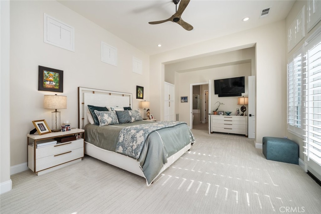 1988 Eucalyptus Road Nipomo, CA 93444 - Photo 33 of 63 a spacious bedroom with a bed a couch and a window