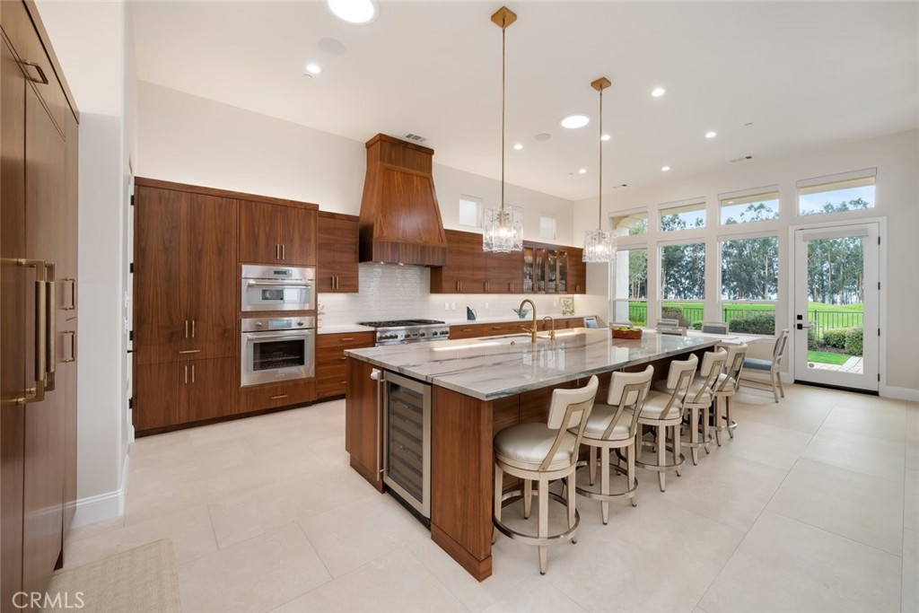 1988 Eucalyptus Road Nipomo, CA 93444 - Photo 8 of 63 a kitchen with stainless steel appliances granite countertop a stove top oven a refrigerator and a view of living room