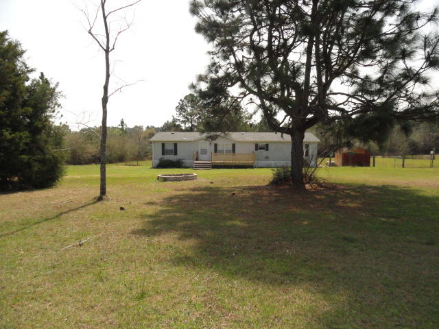 1512 McCauley Road Baker, FL 32531 - Photo 1 of 18 a view of a yard with a tree