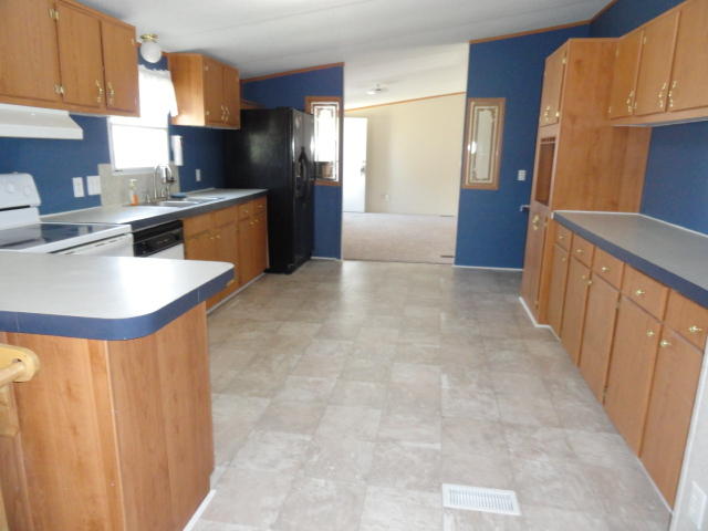 1512 McCauley Road Baker, FL 32531 - Photo 7 of 18 a kitchen with stainless steel appliances granite countertop a refrigerator a stove and a sink
