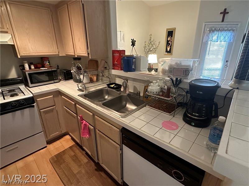 1830 North Pecos Road, Unit 230 Las Vegas, NV 89115 - Photo 10 of 16 Functional kitchen with ample cabinet space, a practical countertop, and a double basin sink.
