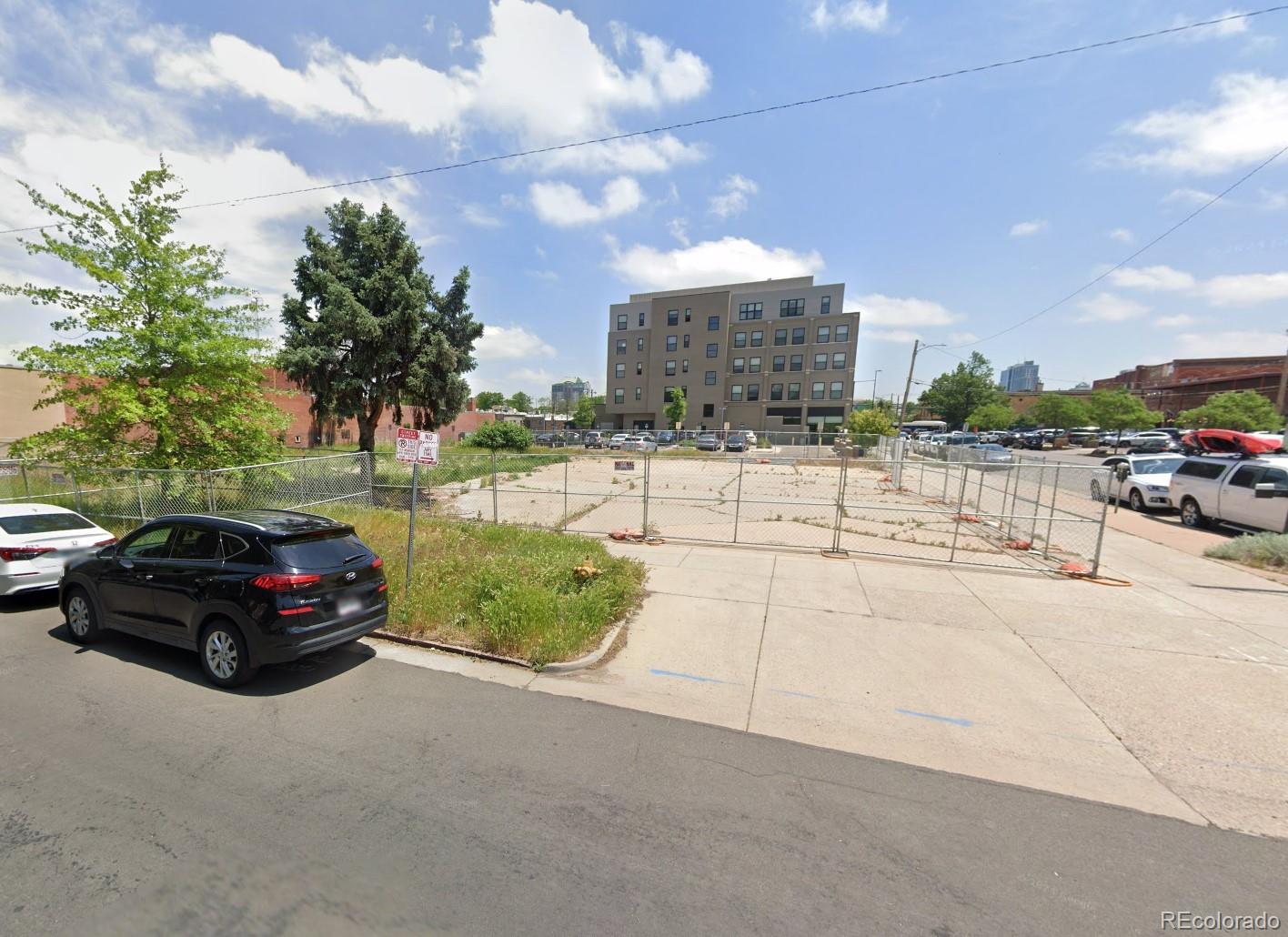 100 Acoma Street Denver, CO 80223 - Photo 2 of 5 a car parked on the side of a street